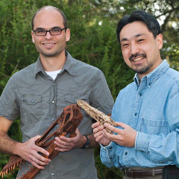 Two 春色视频 professors hold dinosaur fossils