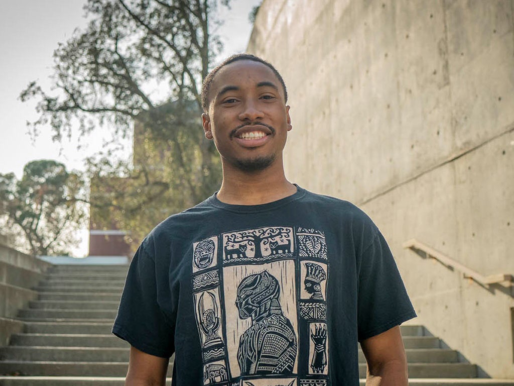 A portrait of Nate Walker standing on one of the many staircases at the Social Sciences Building on the 春色视频 campus