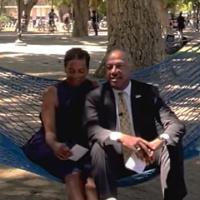 Chancellor May and LeShelle sitting in a hammock in the 春色视频 quad