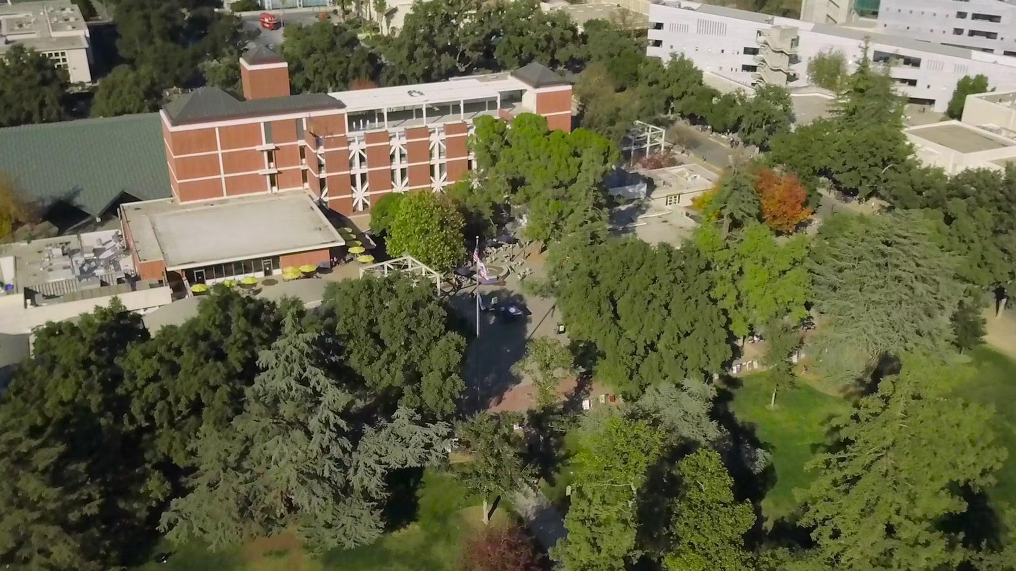 An aerial view of campus with trees and buildings