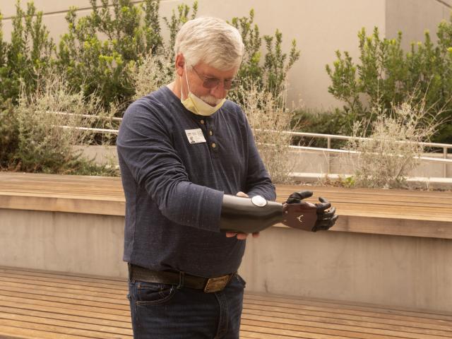 David Brockman, a retired firefighter and hand amputee, shows off his new myoelectric prosthetic device.