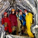 Five 春色视频 researchers inside marble rock formations of cave