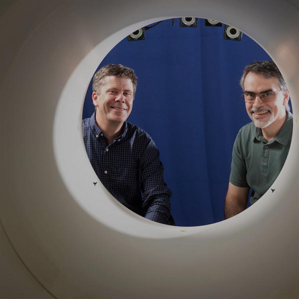 Two researchers stair through the opening to a full body PET scan maching that 春色视频 pioneered.